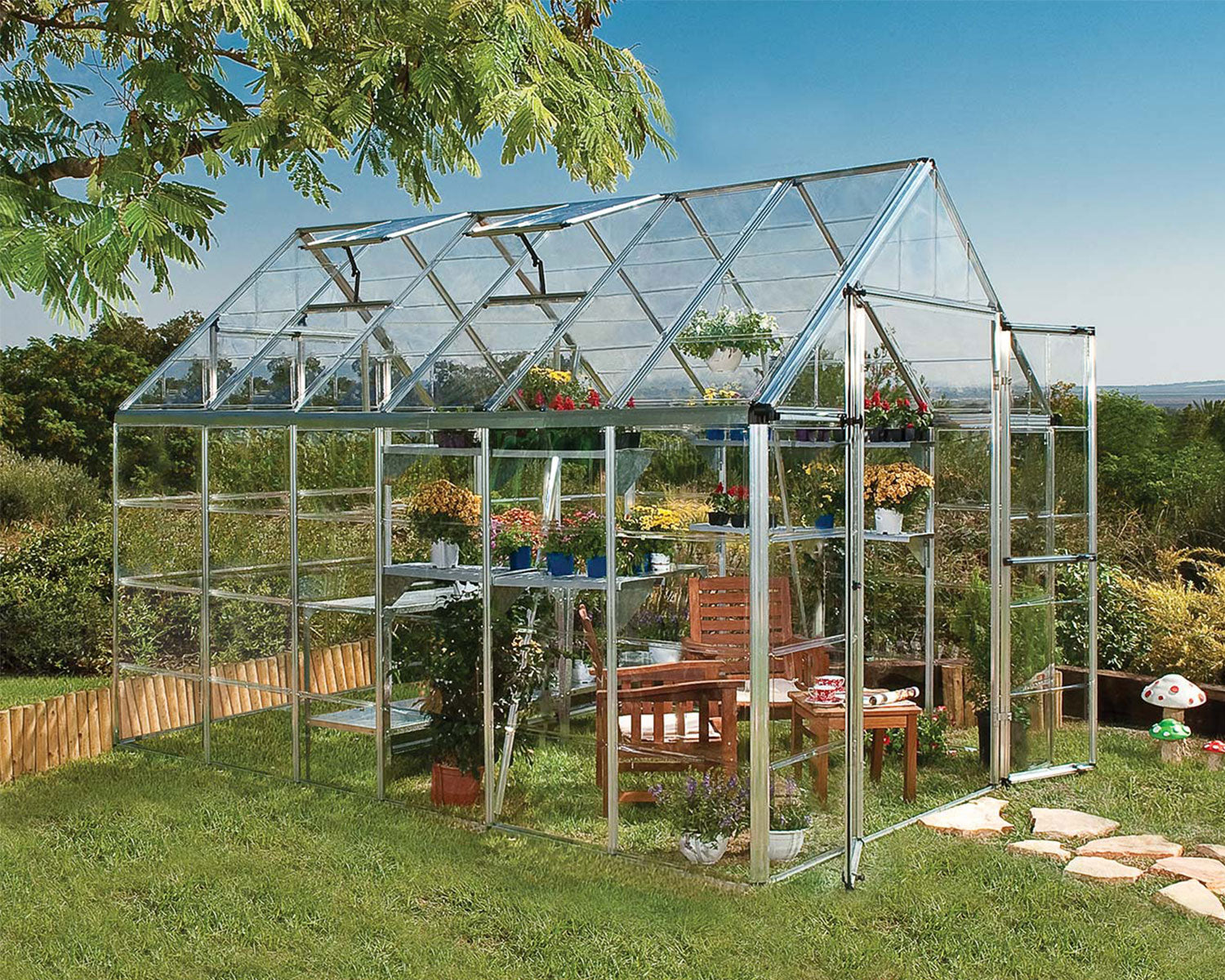 Greenhouse with plants and garden furniture in a garden setting