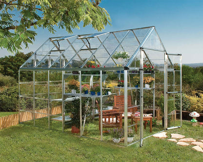 Greenhouse with plants and garden furniture in a garden setting